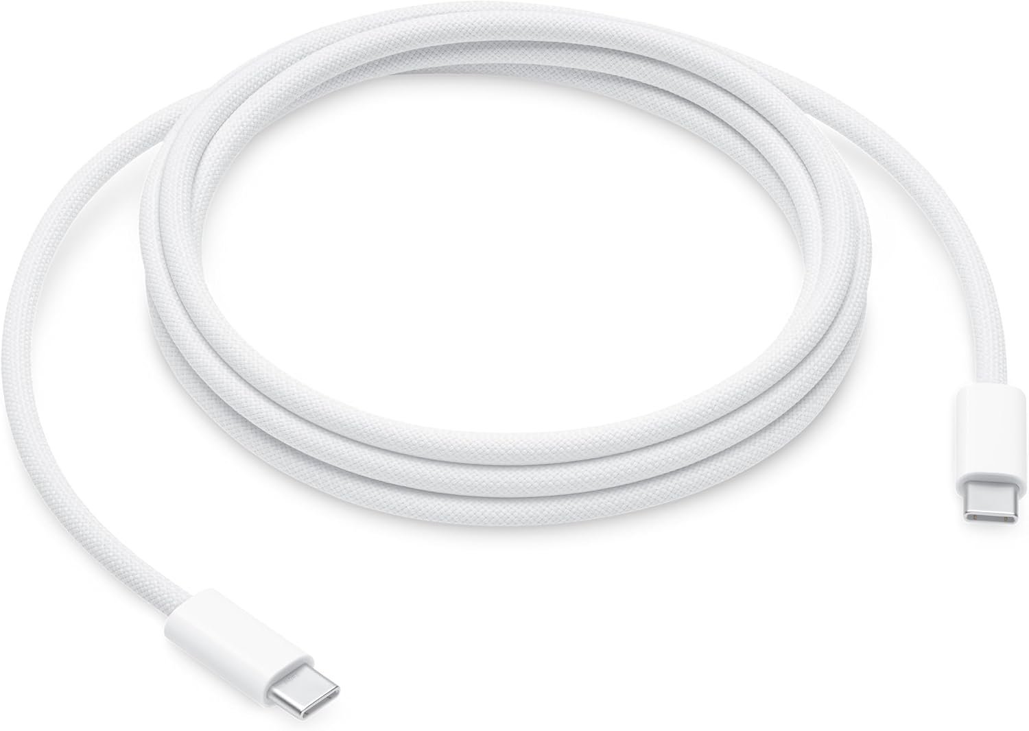 White woven Apple 240W USB-C to USB-C charge cable coiled on a desk, with moulded connectors on both ends.