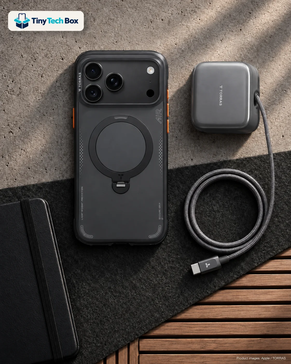 Black iPhone 18 Pro Max in a Shadow Black TORRAS Q3 Air case beside a graphite grey TORRAS FlexLine Pro charger and its braided cable on a charcoal felt desk mat