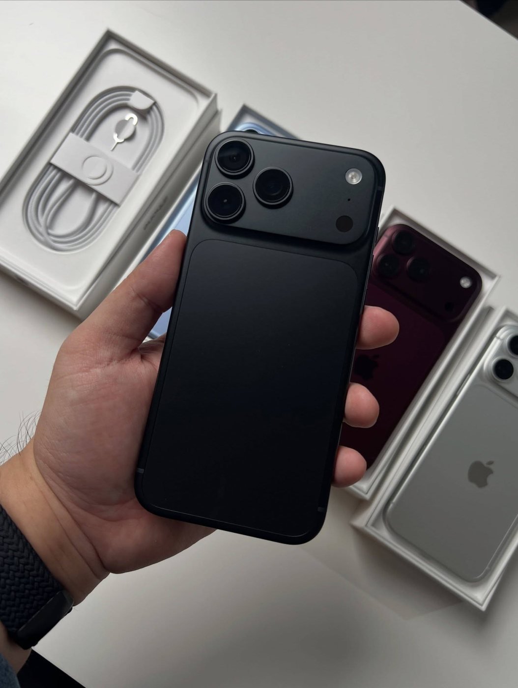 Black iPhone 18 Pro Max held in one hand