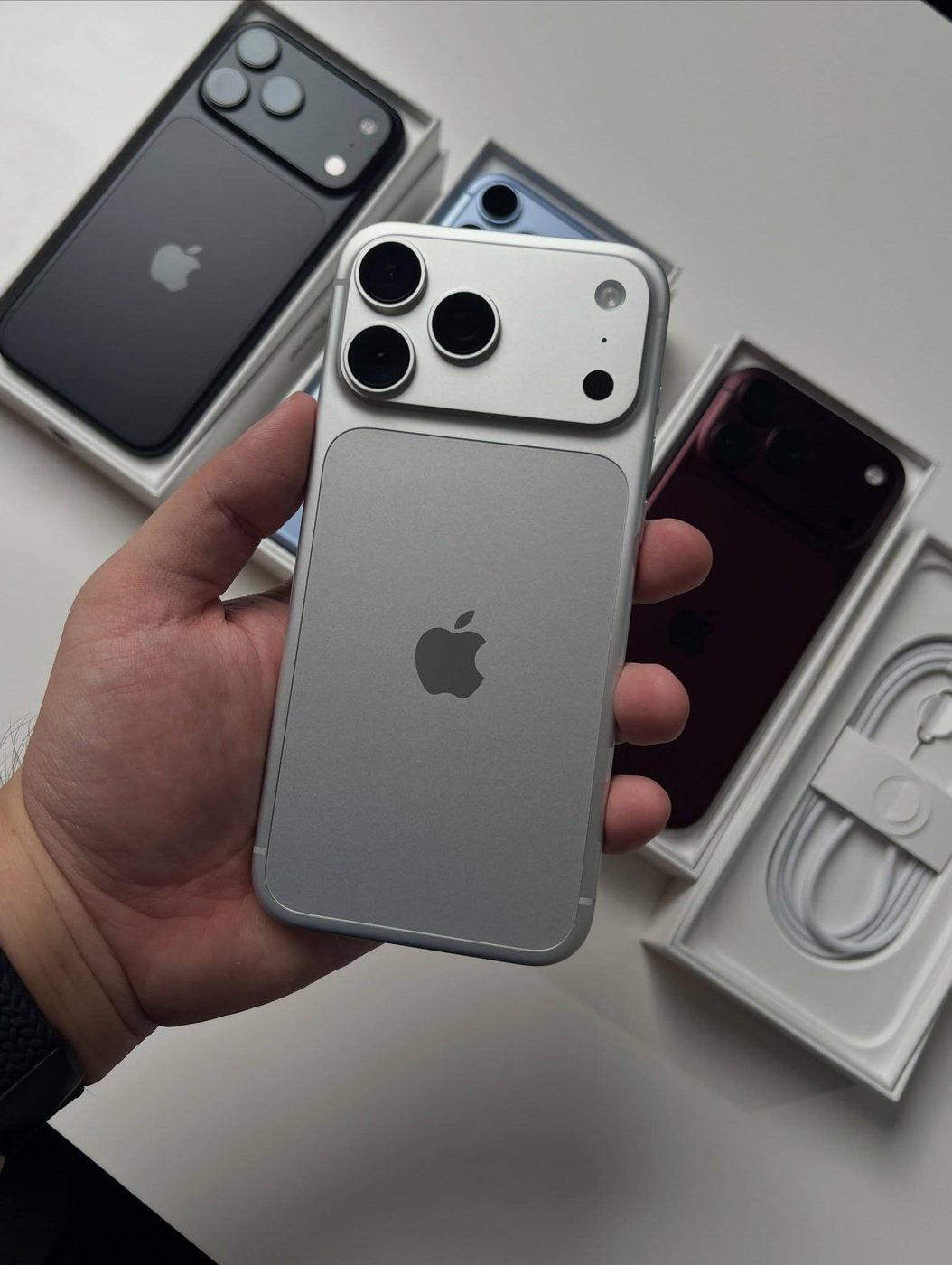 Silver iPhone 18 Pro Max held in one hand