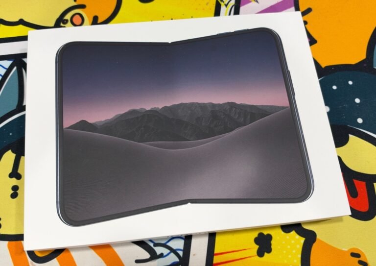 iPhone Duo retail box showing the unfolded phone with a desert and mountain wallpaper